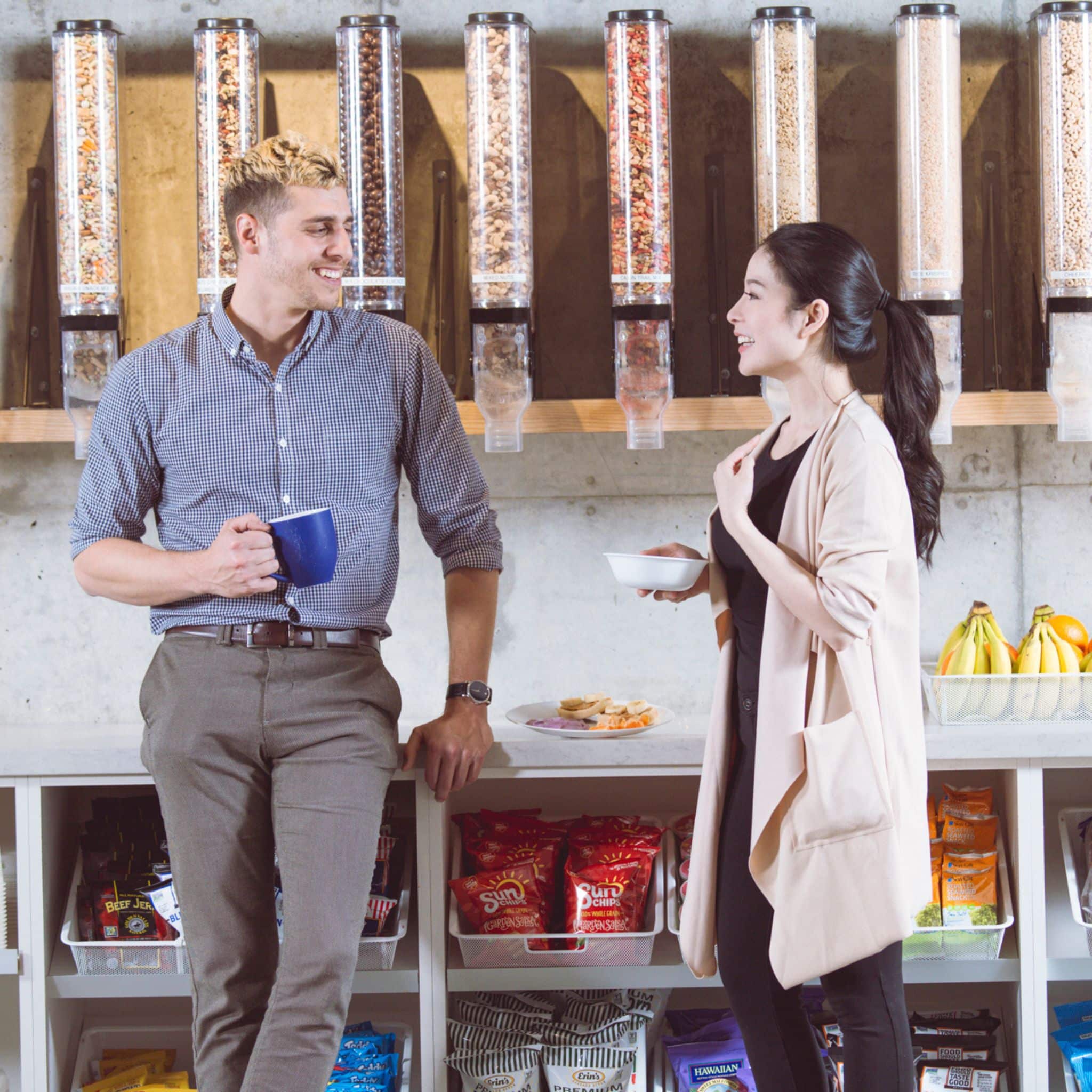Two people talking while holding fresh food and coffee, Canteen pantry service, fresh fruit and snacks